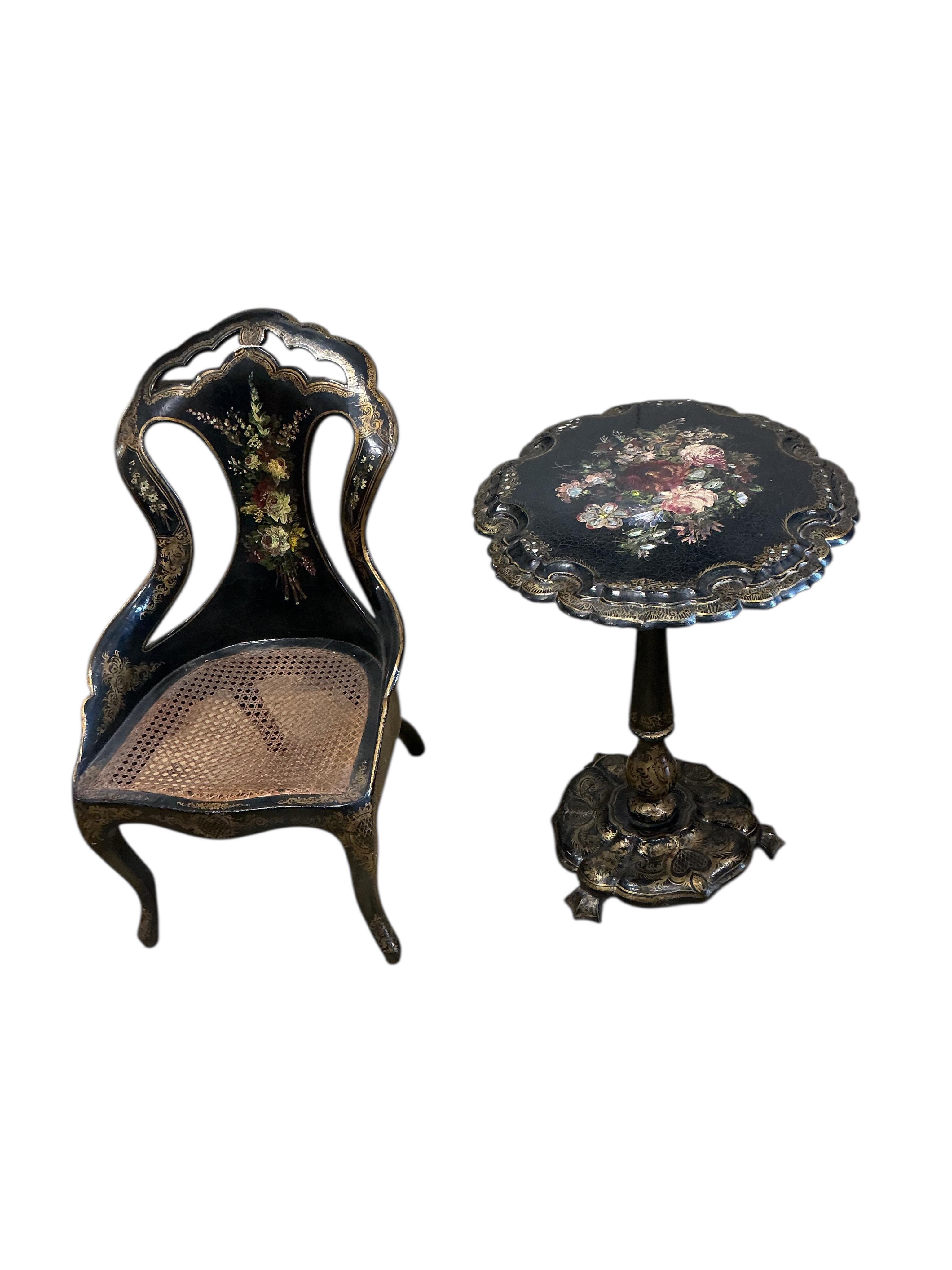 A Victorian mother of pearl inlaid papier-mâché oval tilt top wine table, width 58cm, height 67cm, and a similar cane seat chair